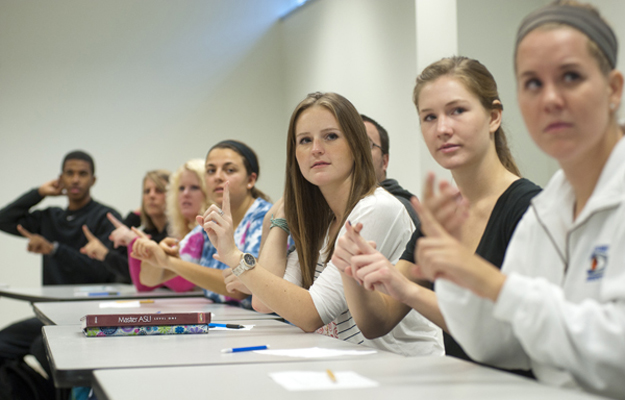 several students signing in a classroom